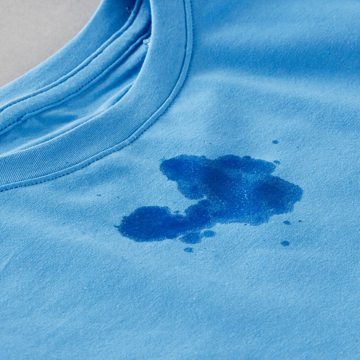 Blue t shirt visibly wet with water soaked through the cotton